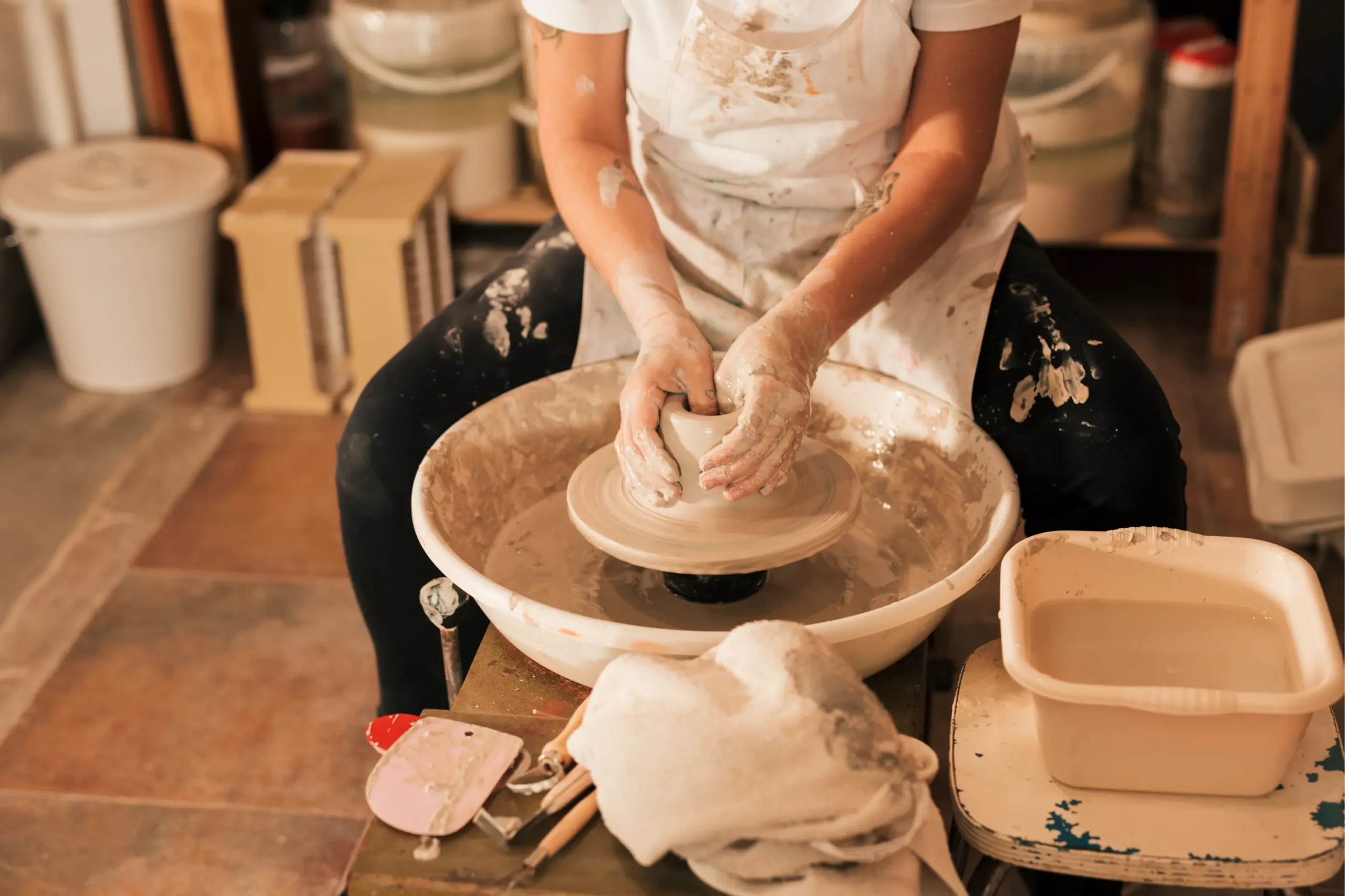 Buggy à la Palmeraie 1 close up female craftsman giving detail clay pottery wheel scaled